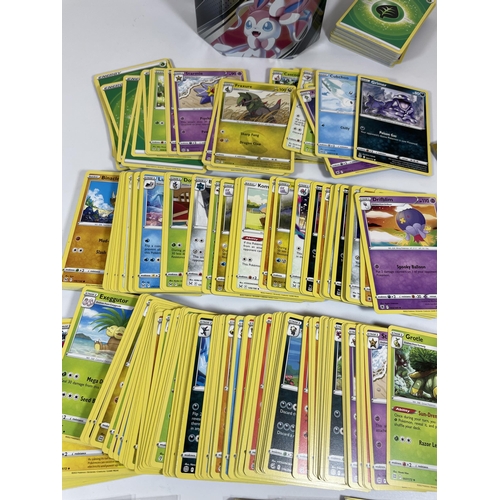 102 - AN UMBREON TIN OF POKEMON TRADING CARDS, HOLOS ETC