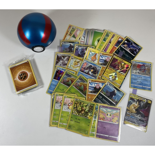 103 - A POKE BALL TIN OF POKEMON TRADING CARDS, HOLOS, PIKACHU GX, SEALED ENERGY PACK ETC