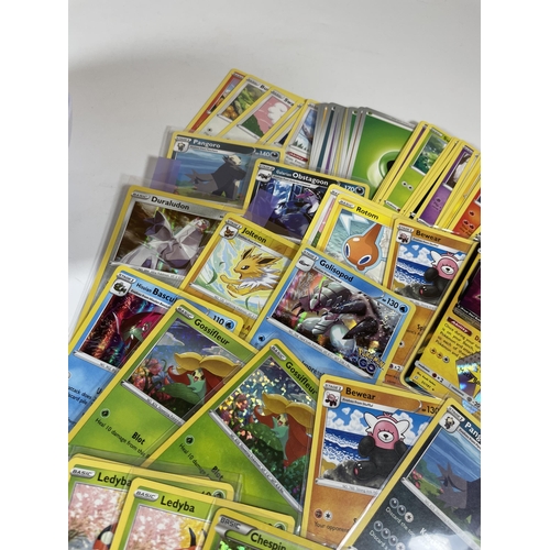 103 - A POKE BALL TIN OF POKEMON TRADING CARDS, HOLOS, PIKACHU GX, SEALED ENERGY PACK ETC