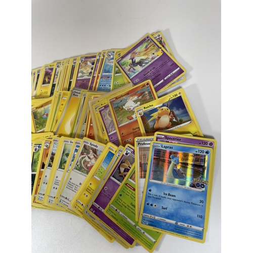 105 - THREE TINS OF ASSORTED POKEMON TRADING CARDS, HOLOS ETC