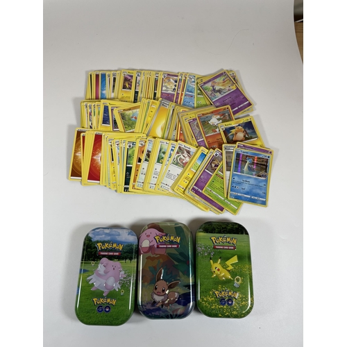 105 - THREE TINS OF ASSORTED POKEMON TRADING CARDS, HOLOS ETC