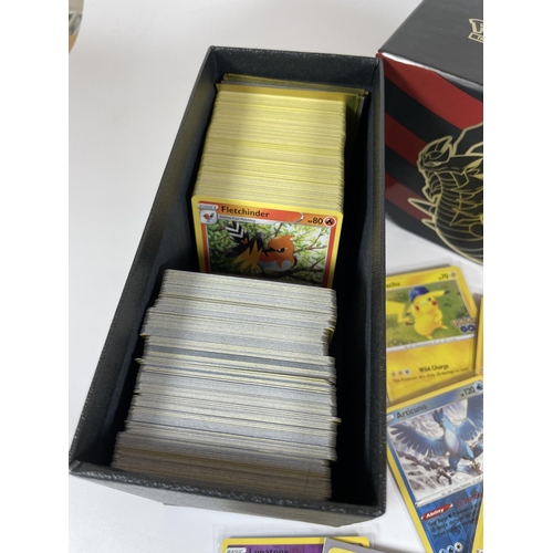 107 - A TRAINER BOX OF ASSORTED POKEMON TRADING CARDS, HOLOS, TOKENS ETC