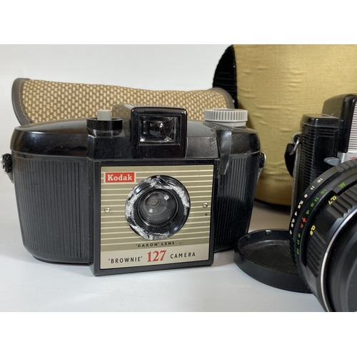 114 - FOUR CAMERA ITEMS - KODAK BROWNIE 127, STARLET BROWNIE WITH DAKON LENS, HELIOS 44MM LENS AND PRAKTIC... 