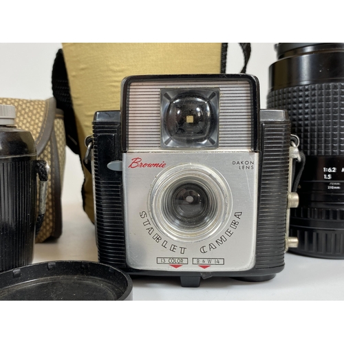 114 - FOUR CAMERA ITEMS - KODAK BROWNIE 127, STARLET BROWNIE WITH DAKON LENS, HELIOS 44MM LENS AND PRAKTIC... 