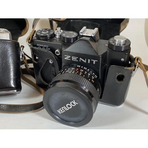 121 - TWO VINTAGE ZENIT CASED CAMERAS - ZENIT E BODY AND ZENIT TTL FITTED WITH KENLOCK MC 28MM LENS