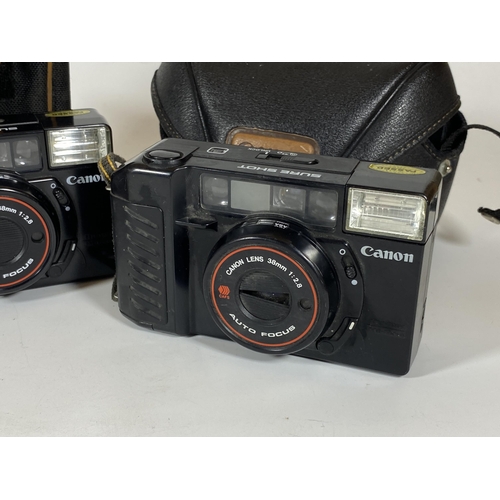 142 - TWO CASED CANON SURE SHOT 38MM CAMERAS