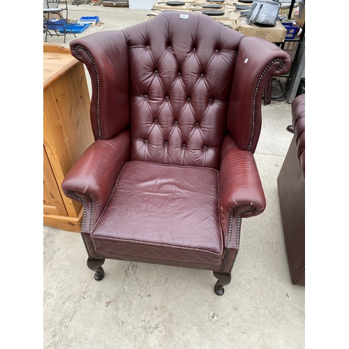 2811 - A RED LEATHER WINGED FIRESIDE CHAIR ON CABRIOLE LEGS