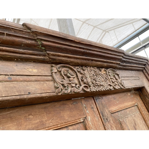 2848 - A PAIR OF INDIAN HARDWOOD PANELLED DOORS WITH BRASS FITTINGS + CARVED CORNICE, 84 X 58