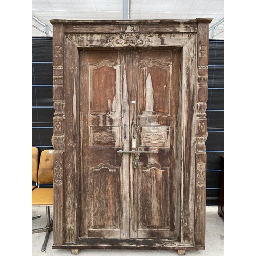 2850 - A PAIR OF INDIAN HARDWOOD PANELLED DOORS, 83 X 56