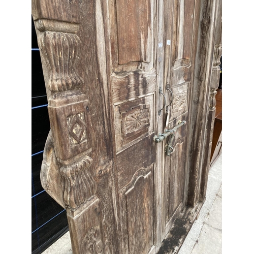 2850 - A PAIR OF INDIAN HARDWOOD PANELLED DOORS, 83 X 56