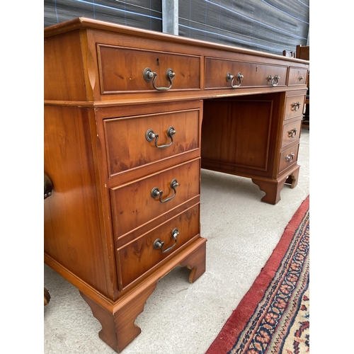 2854 - A MODERN YEW WOOD TWIN PEDESTAL DESK WITH INSET LEATHER TOP ENCLOSING EIGHT DRAWERS, 60