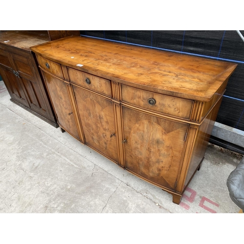 2868 - A YEW WOOD CROSSBANDED BOW FRONTED 'RACKSTRAW' SIDEBOARD ENCLOSING THREE DRAWERS AND THREE CUPBOARDS... 