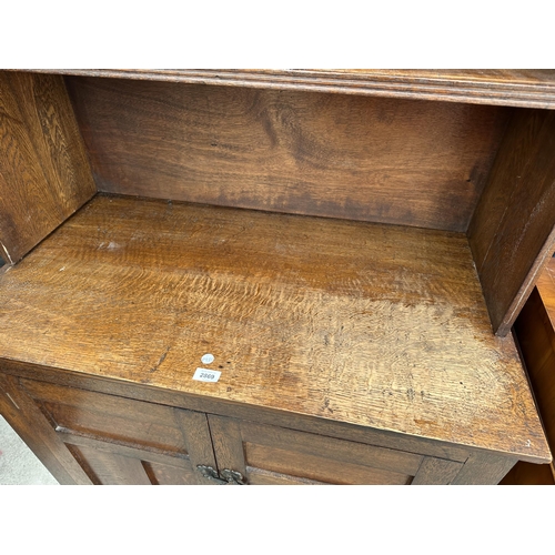 2869 - AN EARLY 20 TH CENTURY OAK TWO DOOR CUPBOARD WITH OPEN TOP SECTION, 37.5