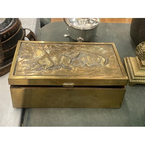 151 - A VINTAGE BRASS BOX WITH AN EMBOSSED IMAGE OF WILD BOARS TO THE LID