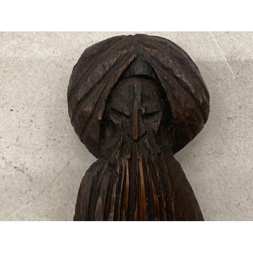 182 - A VINTAGE CARVED WOODEN LETTER OPENER IN THE GUISE OF A HOLY MAN