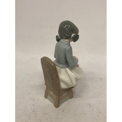 728 - A NAO FIGURINE OF A GIRL SEWING