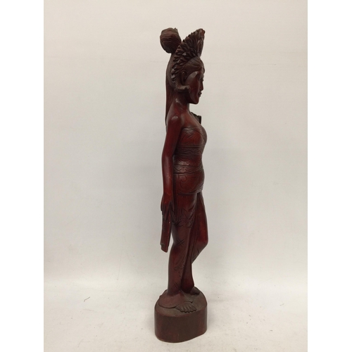 19 - A VINTAGE CARVED WOODEN TRIBAL FIGURE