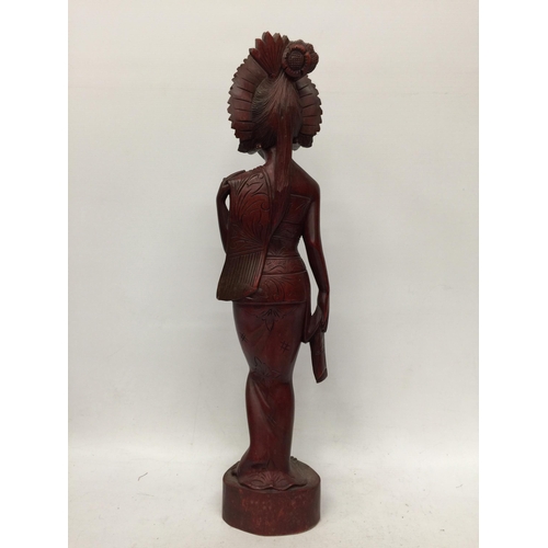 19 - A VINTAGE CARVED WOODEN TRIBAL FIGURE