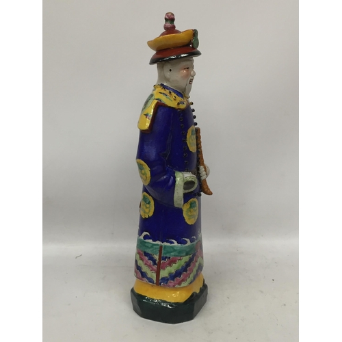 36 - A CHINESE STONEWARE FIGURE WITH SEAL MARK TO BASE