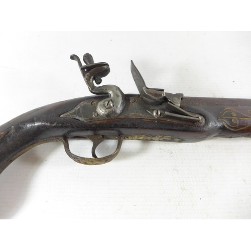 389 - AN INDIAN FLINTLOCK PISTOL, 26CM BARREL, THE STOCK WITH WIRE WORK DECORATION, LENGTH 45CM