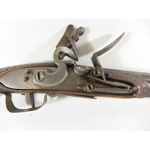 390 - AN INDIAN FLINTLOCK PISTOL, 26CM FLARED MUZZLE BARREL WITH WHITE METAL INLAY, STOCK WITH NAIL DECORA... 