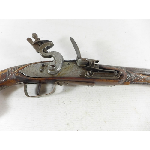 390 - AN INDIAN FLINTLOCK PISTOL, 26CM FLARED MUZZLE BARREL WITH WHITE METAL INLAY, STOCK WITH NAIL DECORA... 