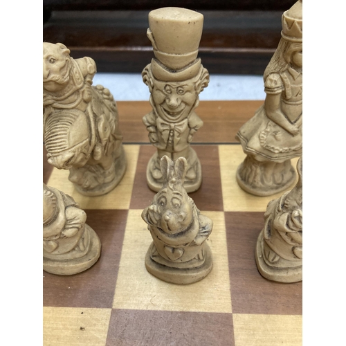 31 - A CHESS SET WITH A WOODEN BOARD AND ALICE IN WONDERLAND THEMED PLAYING PIECES