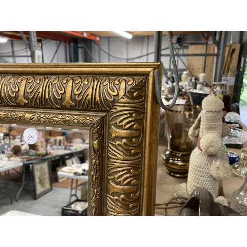 912 - A LARGE ORNATE RECTANGULAR GILT FRAMED MIRROR