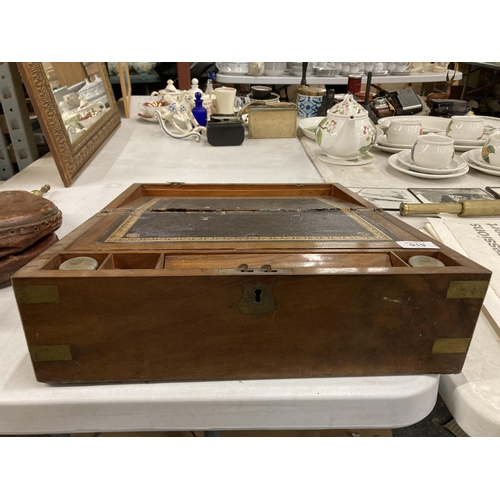 919 - A VICTORIAN MAHOGANY WRITING SLOPE WITH INKWELLS