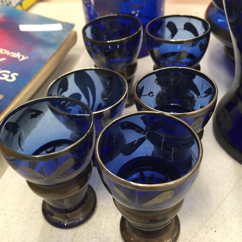 495 - A VINTAGE BLUE GLASS WITH GILT DECORATION DECANTER, STORAGE JAR, VASE AND GLASSES PLUS FOUR CRANBERR... 