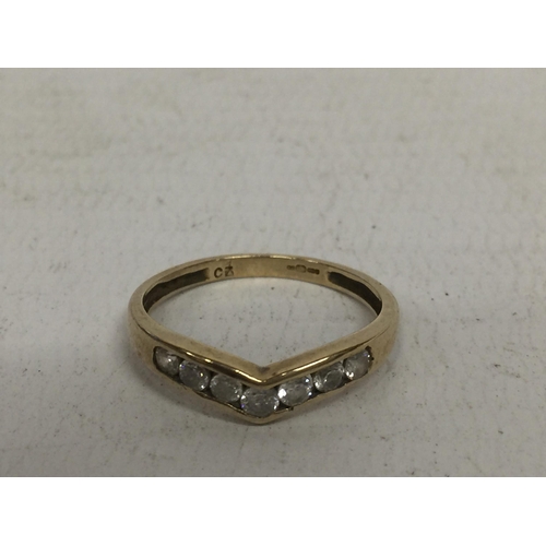 645 - A 9 CARAT GOLD RING WITH SEVEN CUBIC ZIRCONIA STONES