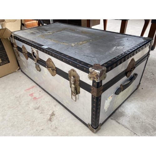 1877 - A LARGE HARD CASED TRAVEL TRUNK