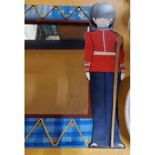 853 - A HEAVY CHILD'S WOODEN BEDROOM MIRROR WITH SOLDIER DECORATION 46CM X 66CM