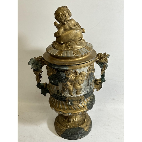 100 - A 19TH CENTURY BRONZE PEDESTAL URN WITH NEO-CLASSICAL RELIEF DESIGN ON FLUTED BASE WITH CHERUB FIGUR... 