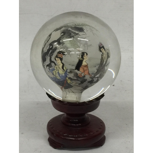 437 - A MODERN ORIENTAL GLASS ORB ON STAND