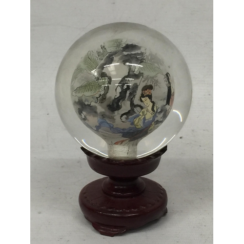 437 - A MODERN ORIENTAL GLASS ORB ON STAND