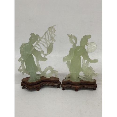 440 - TWO CHINESE JADE TYPE CARVED FIGURES ON STANDS