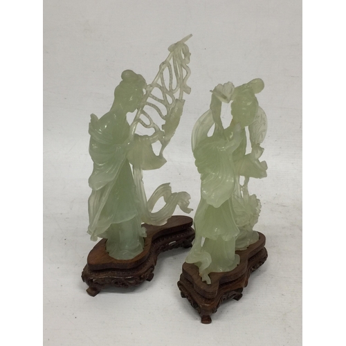 440 - TWO CHINESE JADE TYPE CARVED FIGURES ON STANDS