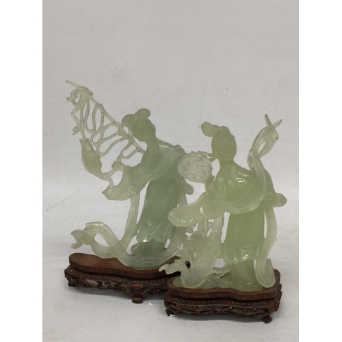 440 - TWO CHINESE JADE TYPE CARVED FIGURES ON STANDS