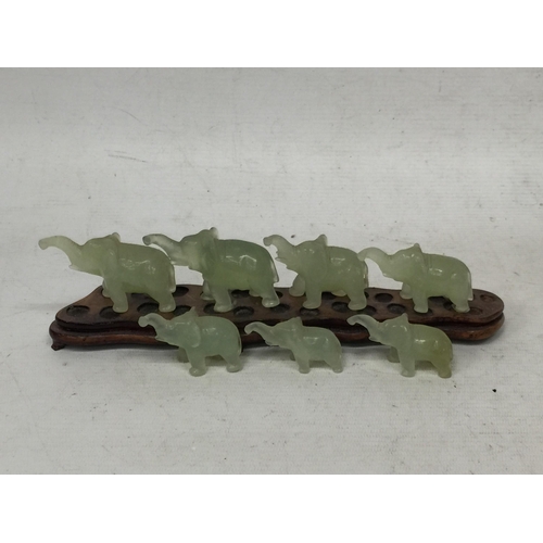 441 - A SET OF CHINESE JADE TYPE ELEPHANTS ON WOODEN STAND