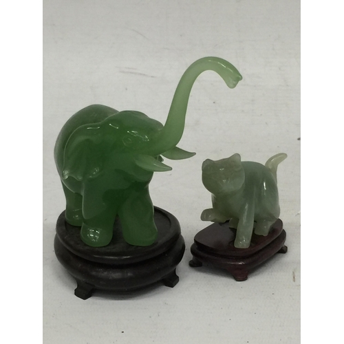 443 - TWO JADE TYPE ANIMAL FIGURES ON STANDS - ELEPHANT AND CAT