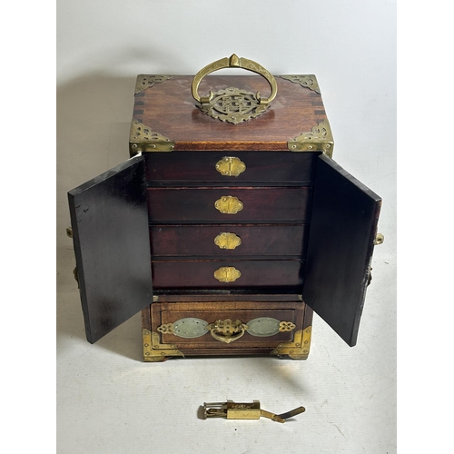 99 - AN ORIENTAL JEWELLERY CABINET, WITH HIDDEN DRAWERS AND BRASS FITTINGS, ALONG WITH JADE STYLE INSERTS... 