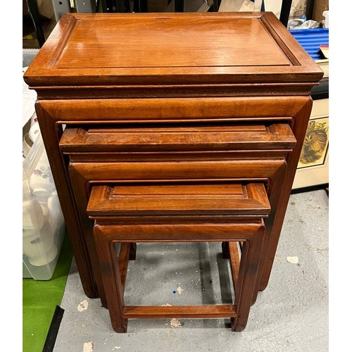 450 - A VINTAGE NEST OF THREE ORIENTAL YEW WOOD TABLES