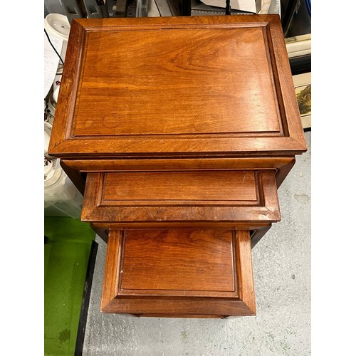 450 - A VINTAGE NEST OF THREE ORIENTAL YEW WOOD TABLES