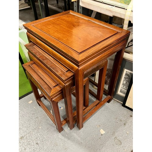 450 - A VINTAGE NEST OF THREE ORIENTAL YEW WOOD TABLES