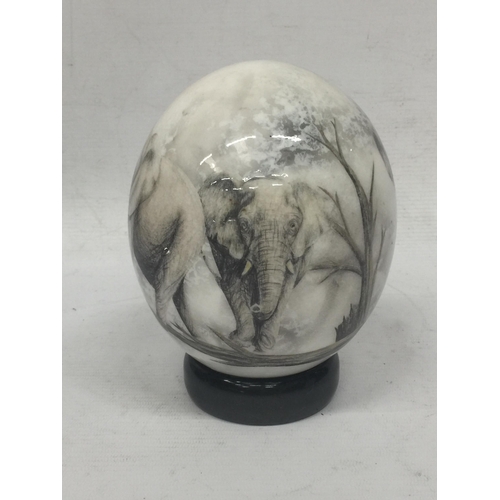 22 - A HANDPAINTED OSTRICH EGG WITH ELEPHANT DESIGN ON STAND
