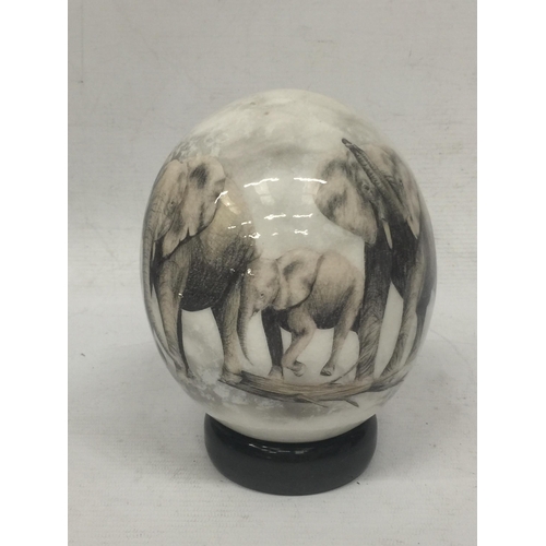 22 - A HANDPAINTED OSTRICH EGG WITH ELEPHANT DESIGN ON STAND