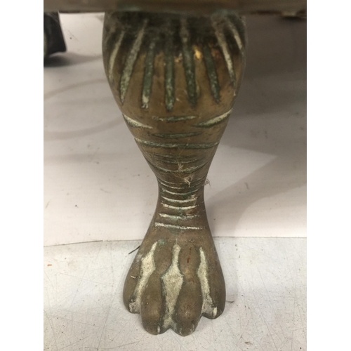 43 - A LARGE BRASS BOWL ON PAW FEET WITH FIGURAL HANDLES