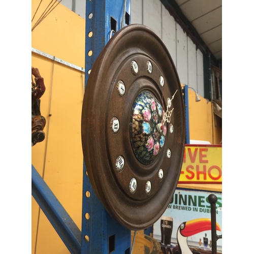 45 - A CIRCULAR WOODEN WALL CLOCK WITH ENAMEL HOUR MARKERS AND COLOURED ENAMELLED DIAL