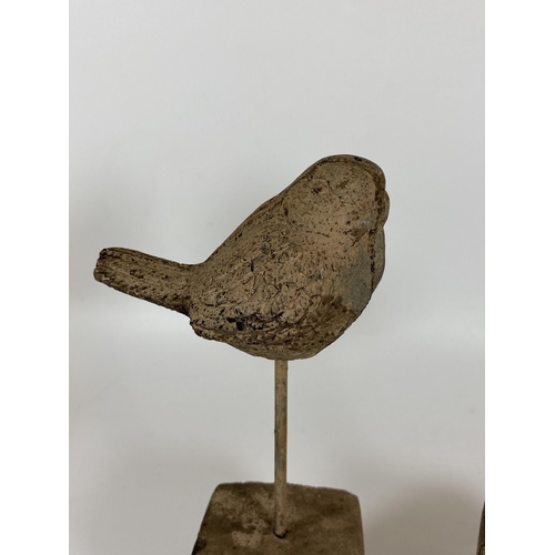 102 - A PAIR OF DECORATIVE STONE BIRD FIGURES ON PLINTH BASES, HEIGHT 24CM